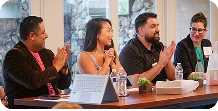 Four people sitting at a judging panel